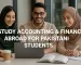 hree Pakistani students—two women in hijabs and a man wearing glasses—sit at a table in a bright, modern classroom. They collaborate over a laptop and open books, smiling as they engage in their Accounting and Finance studies.